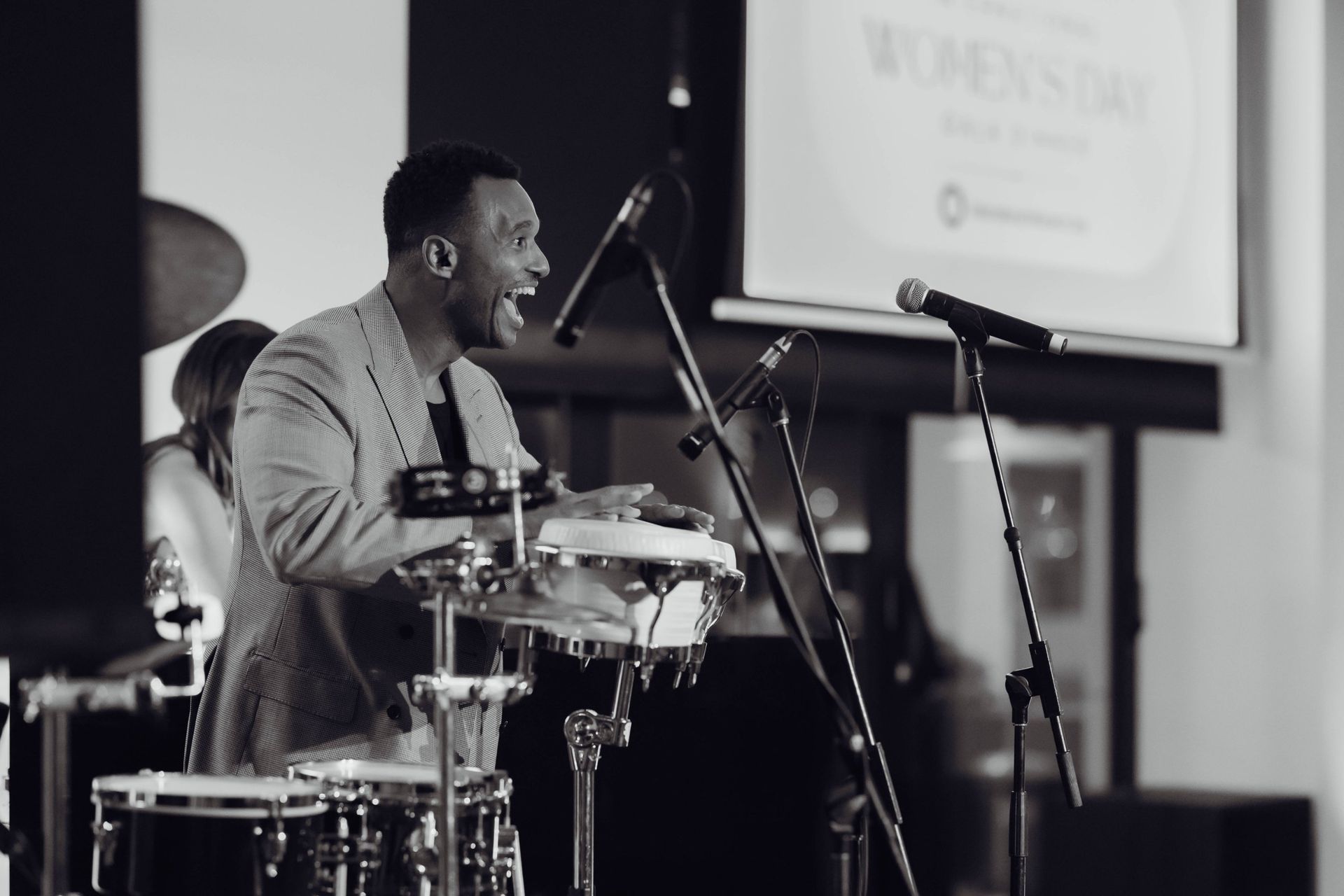 Black and white photo of a percussionist performing at the EverLend International Women's Day Charity Gala