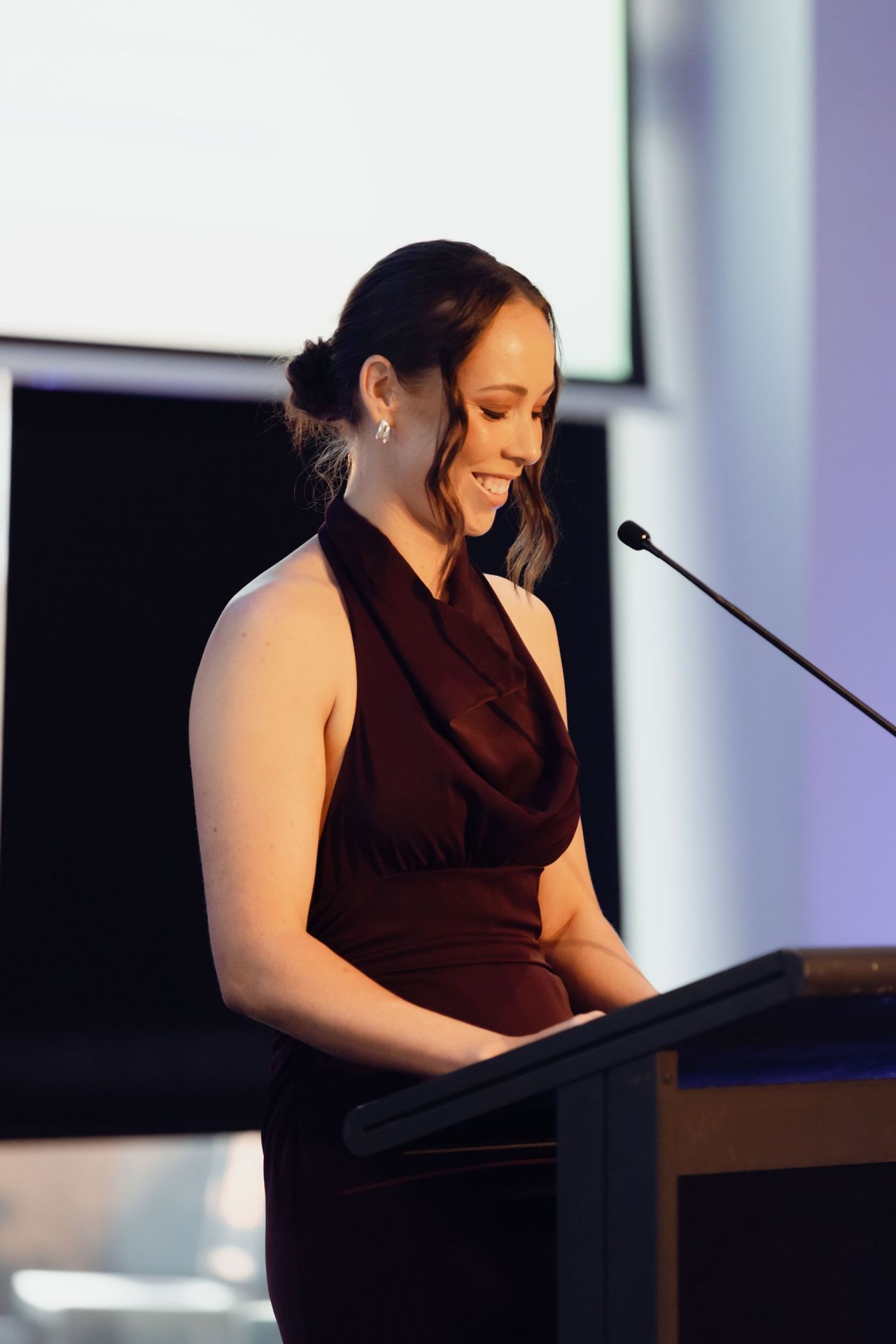Speaker at the podium at the EverLend International Women's Day Charity Gala