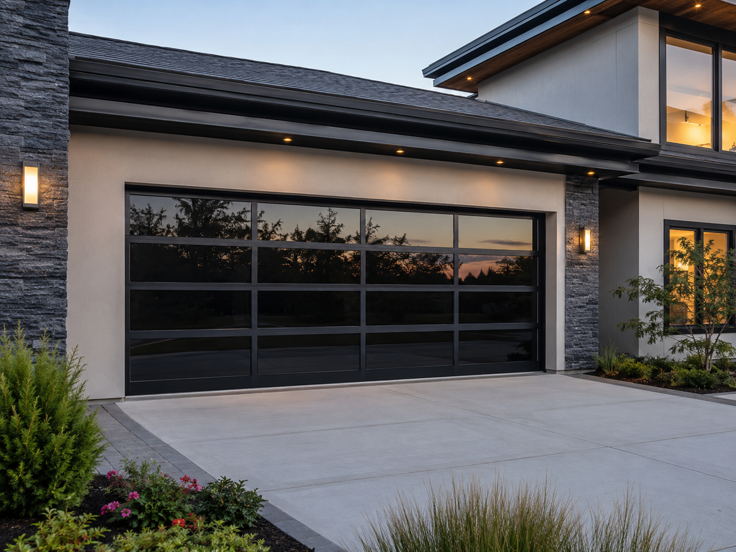 Modern home exterior with a black glass garage door and lit windows at dusk