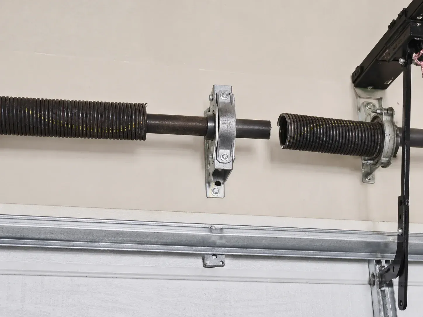 Broken garage door torsion spring on a residential overhead garage door system