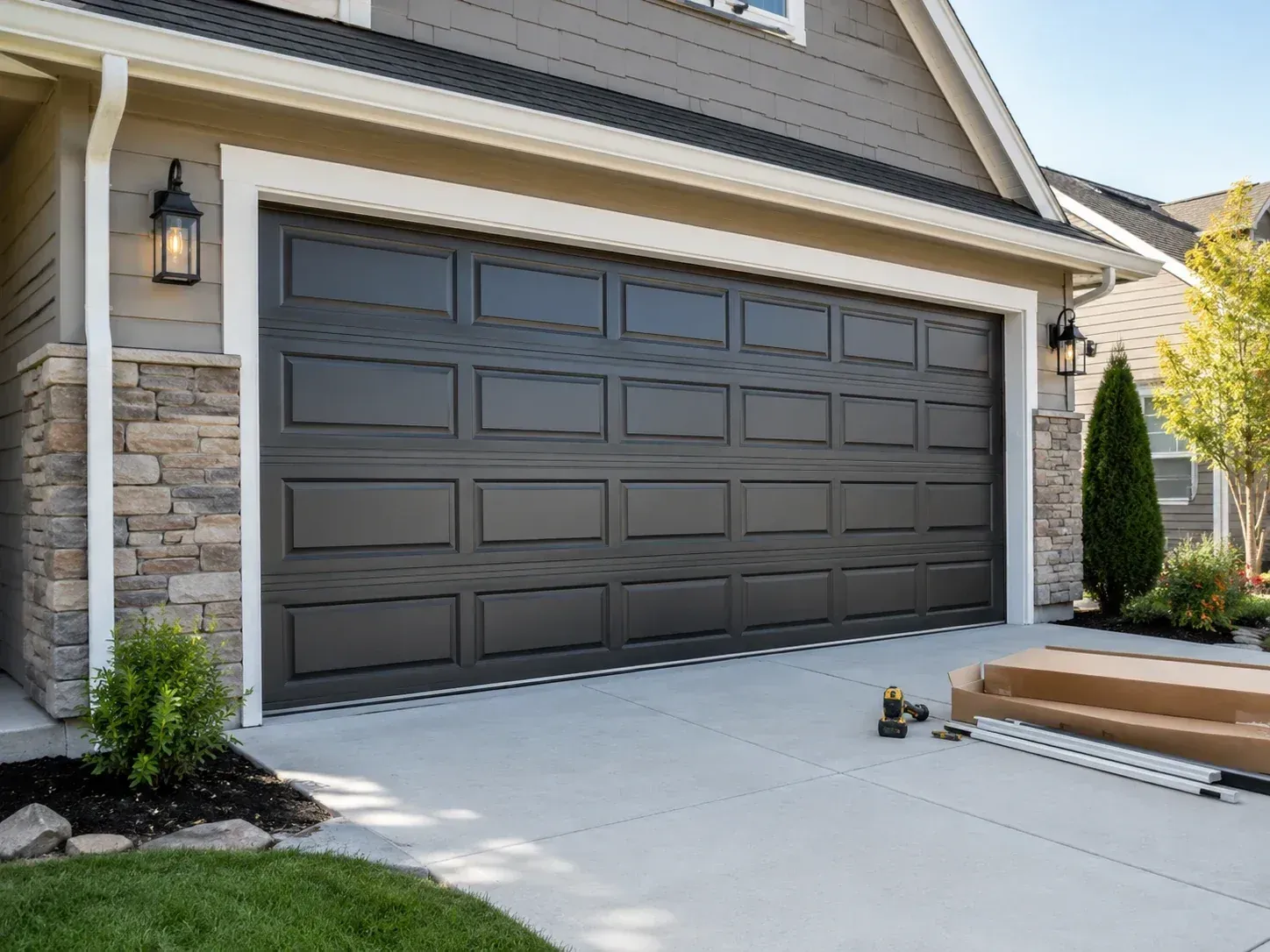 Charcoal aluminum garage door installation on a residential home