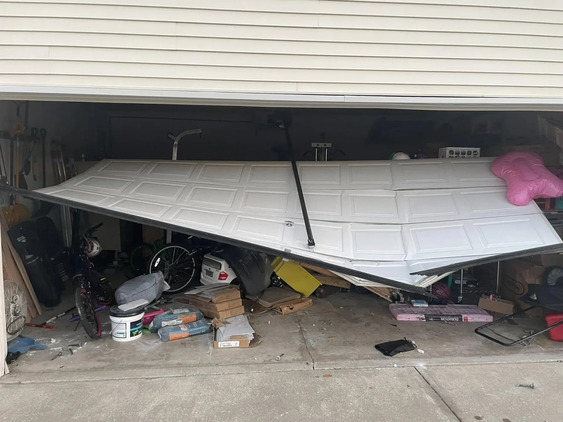 Garage door off track and stuck open inside a residential garage in Roscoe IL