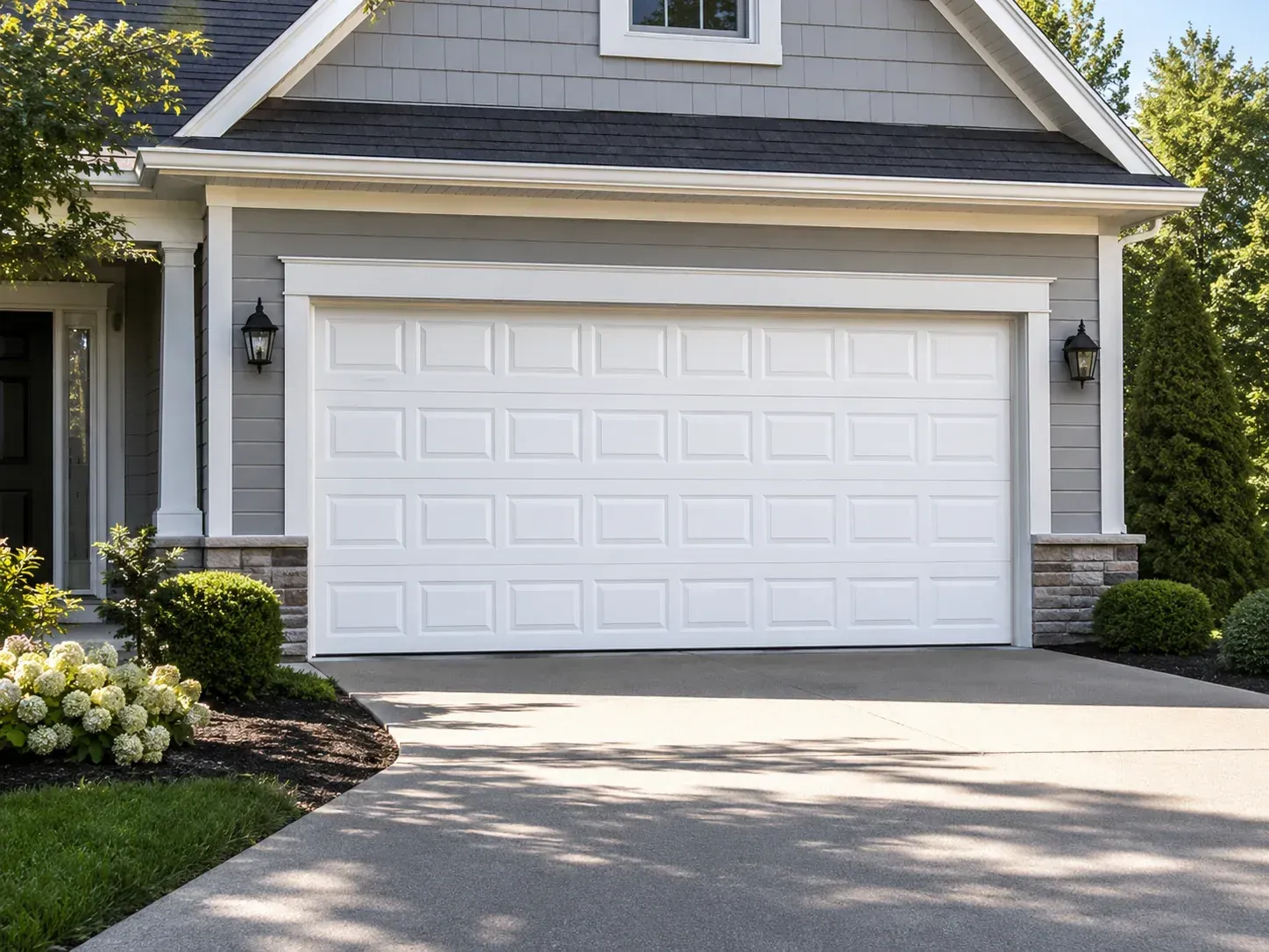 Traditional white vinyl garage door with classic raised panels