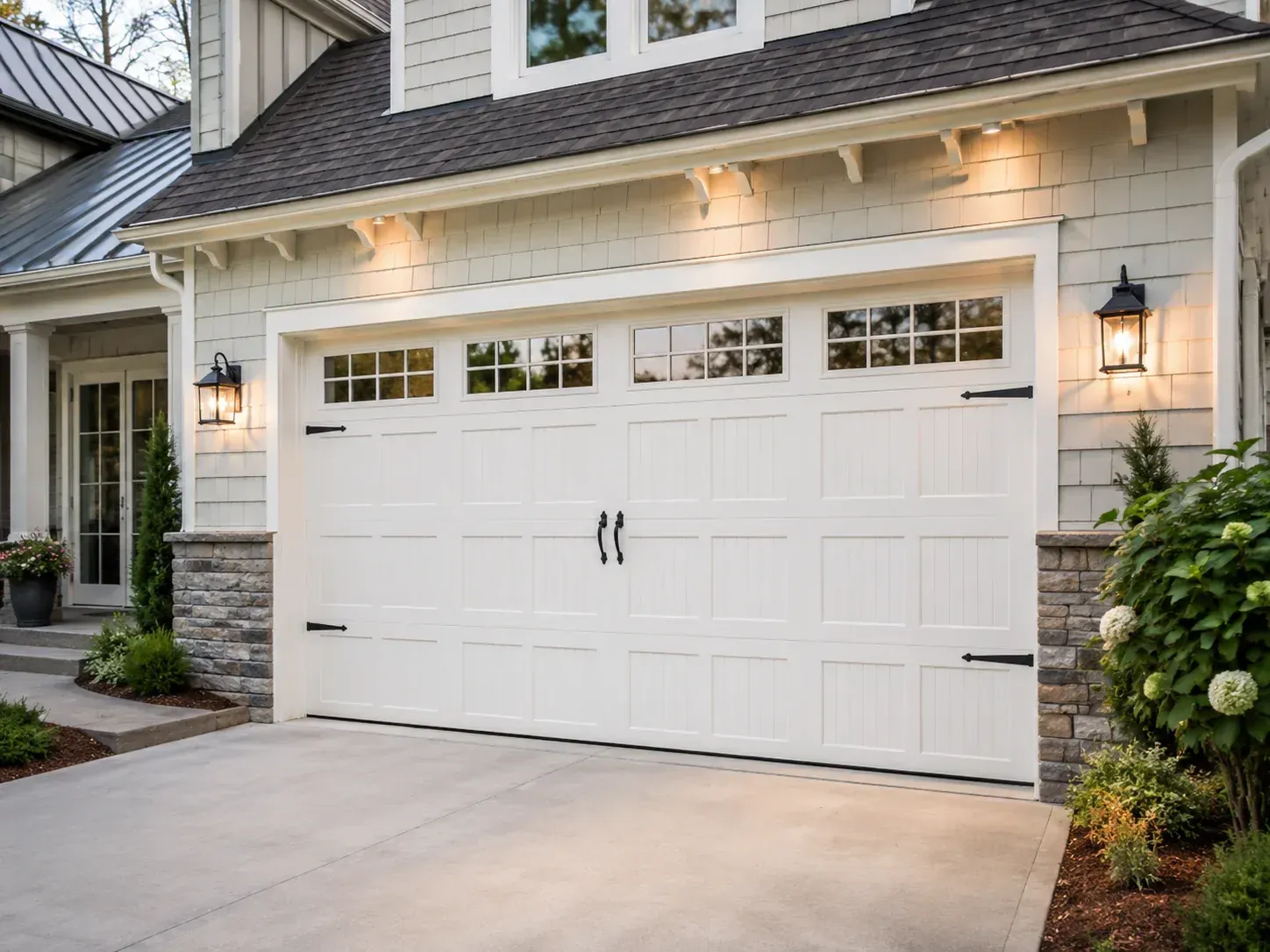 White carriage house style vinyl garage door with windows on a residential home
