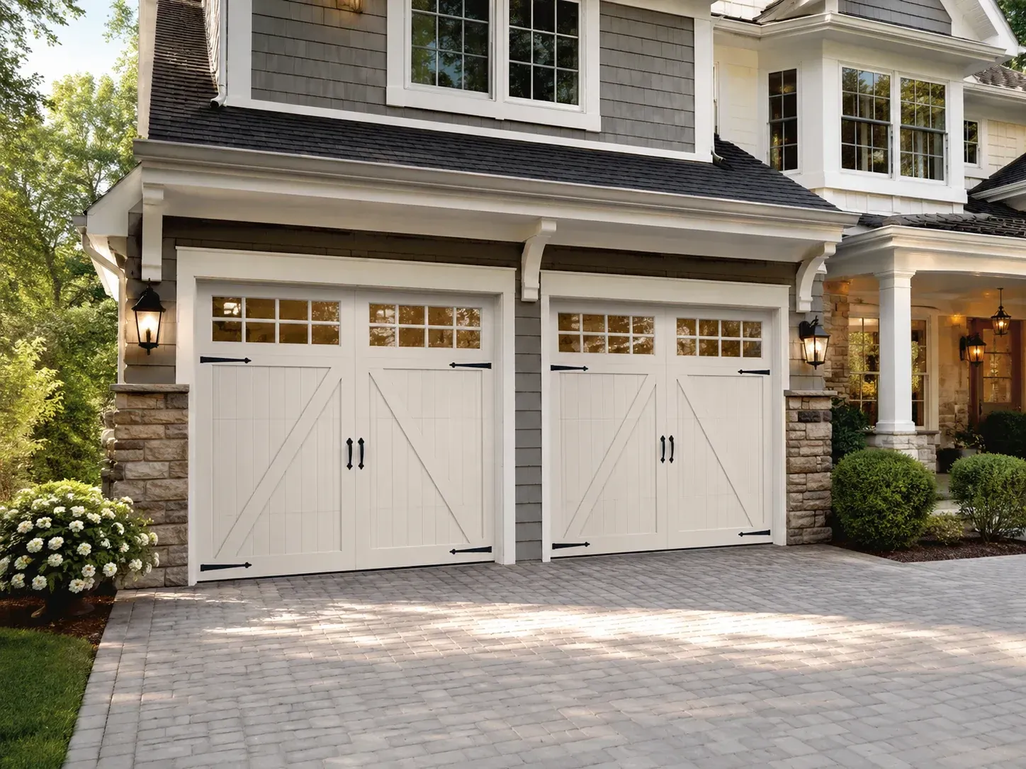White carriage-style garage doors with windows and decorative hardware in Roscoe IL