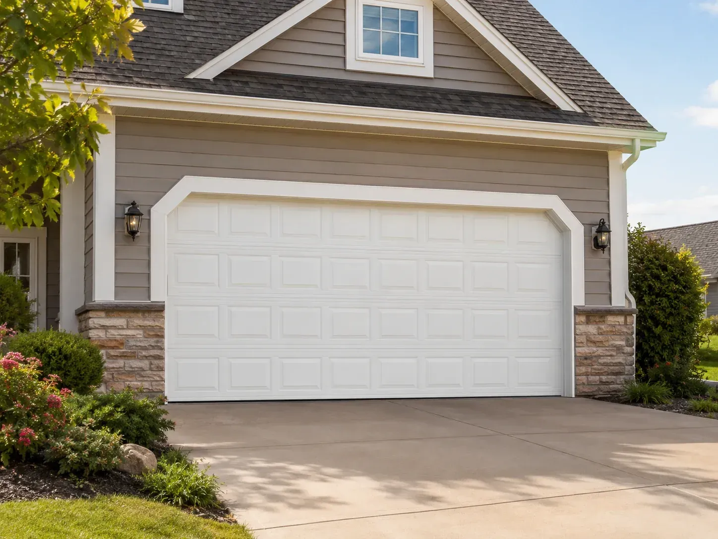 White vinyl garage door with top window panels and landscaped driveway