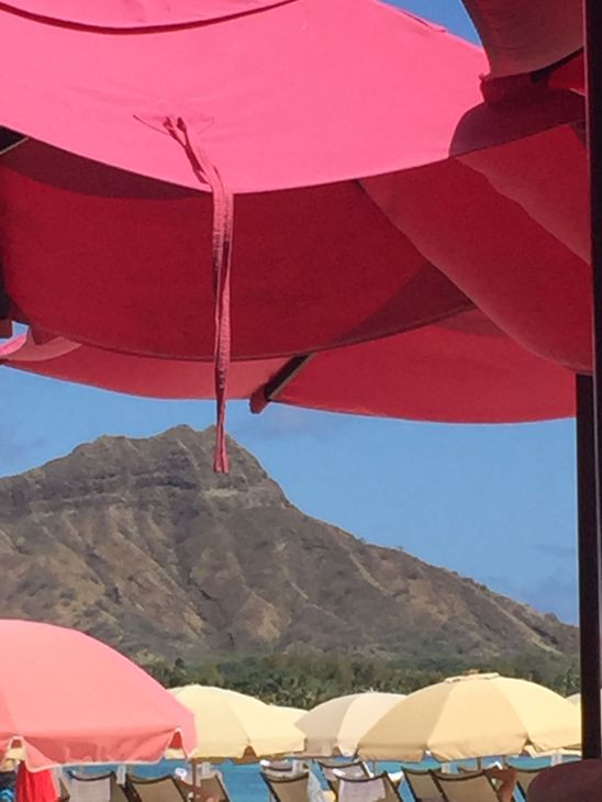 Pink umbrellas on Waikiki Beach with Diamond Head, Oahu