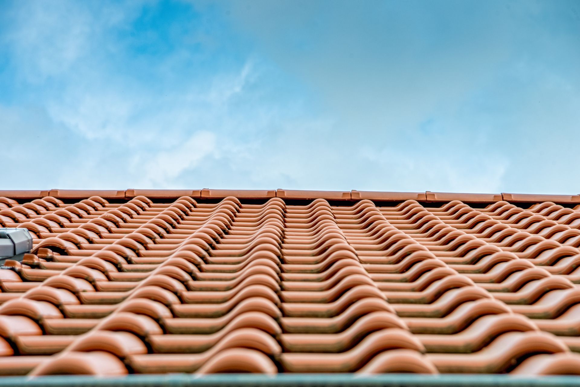 Terracotta tiled roof against a blue sky Terracotta tiled roof against a blue sky