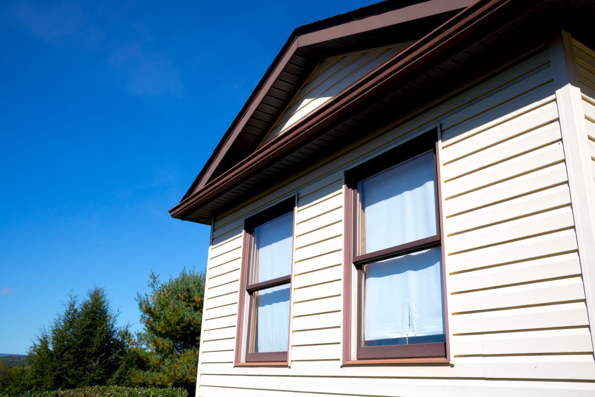 White house exterior with two windows under a blue sky White house exterior with two windows under a blue sky