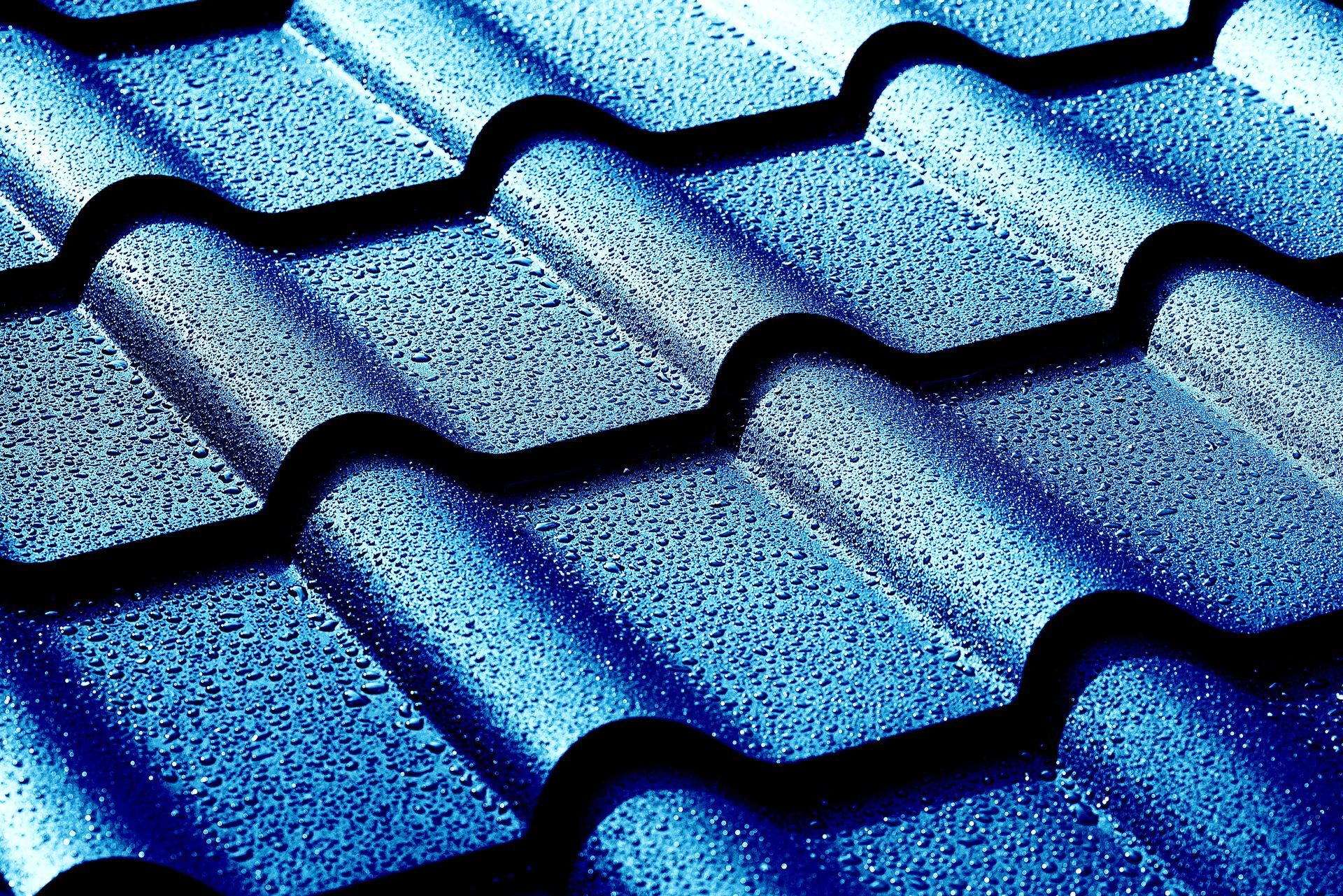 Blue textured roof tiles in a close-up view Blue textured roof tiles in a close-up view