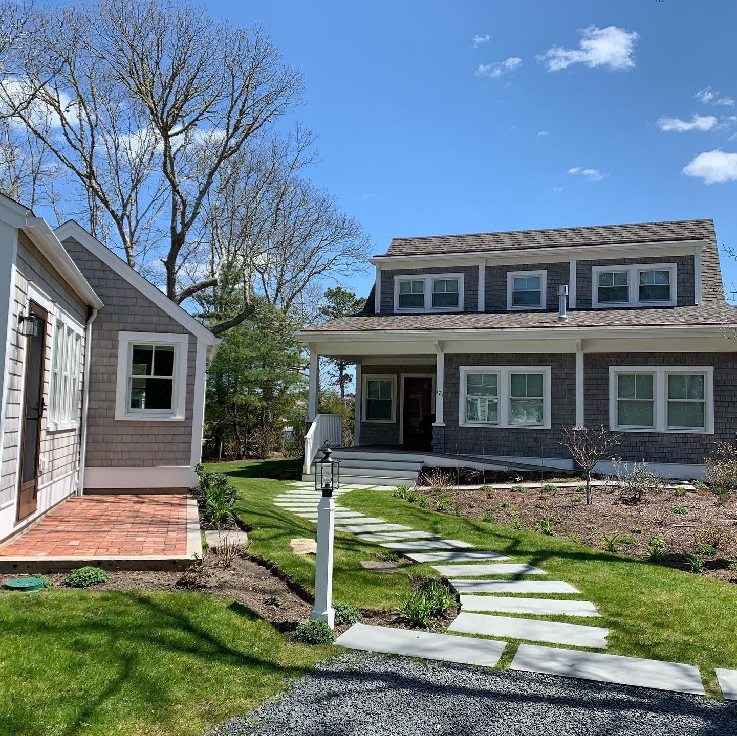 Freshly cleaned Cape Cod home exterior showcasing clean windows and front yard