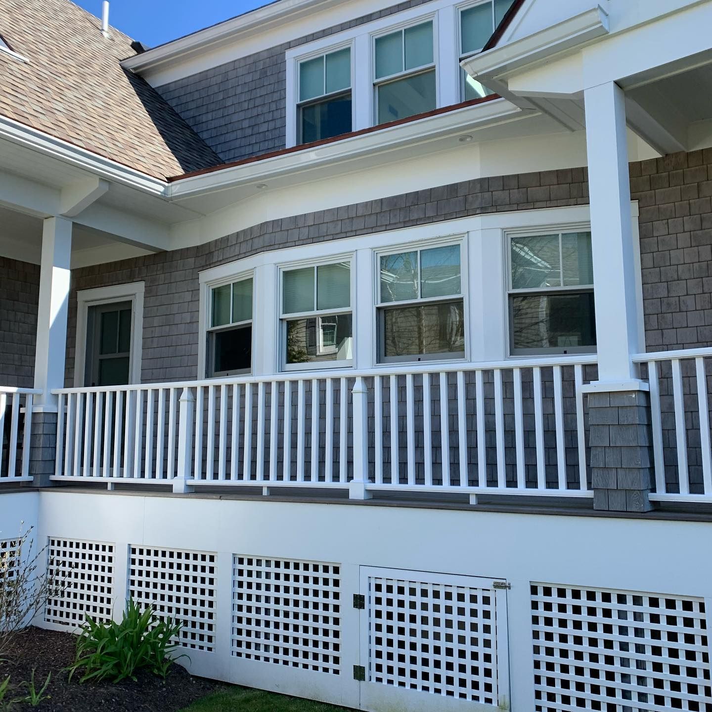 Porch view with clean windows and white railings at Cape Cod property