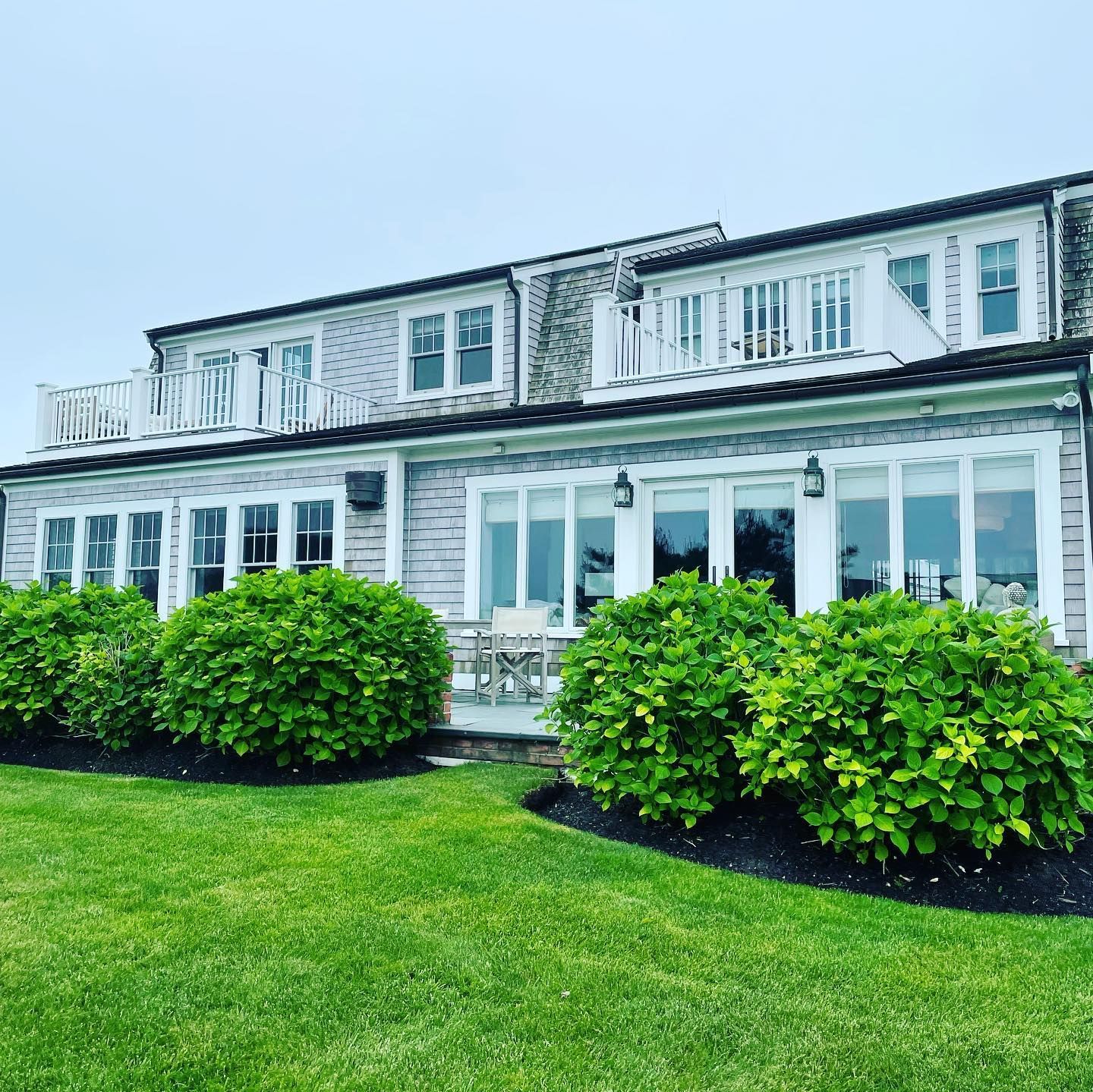 Sparkling windows on Cape Cod home with well-maintained landscaping
