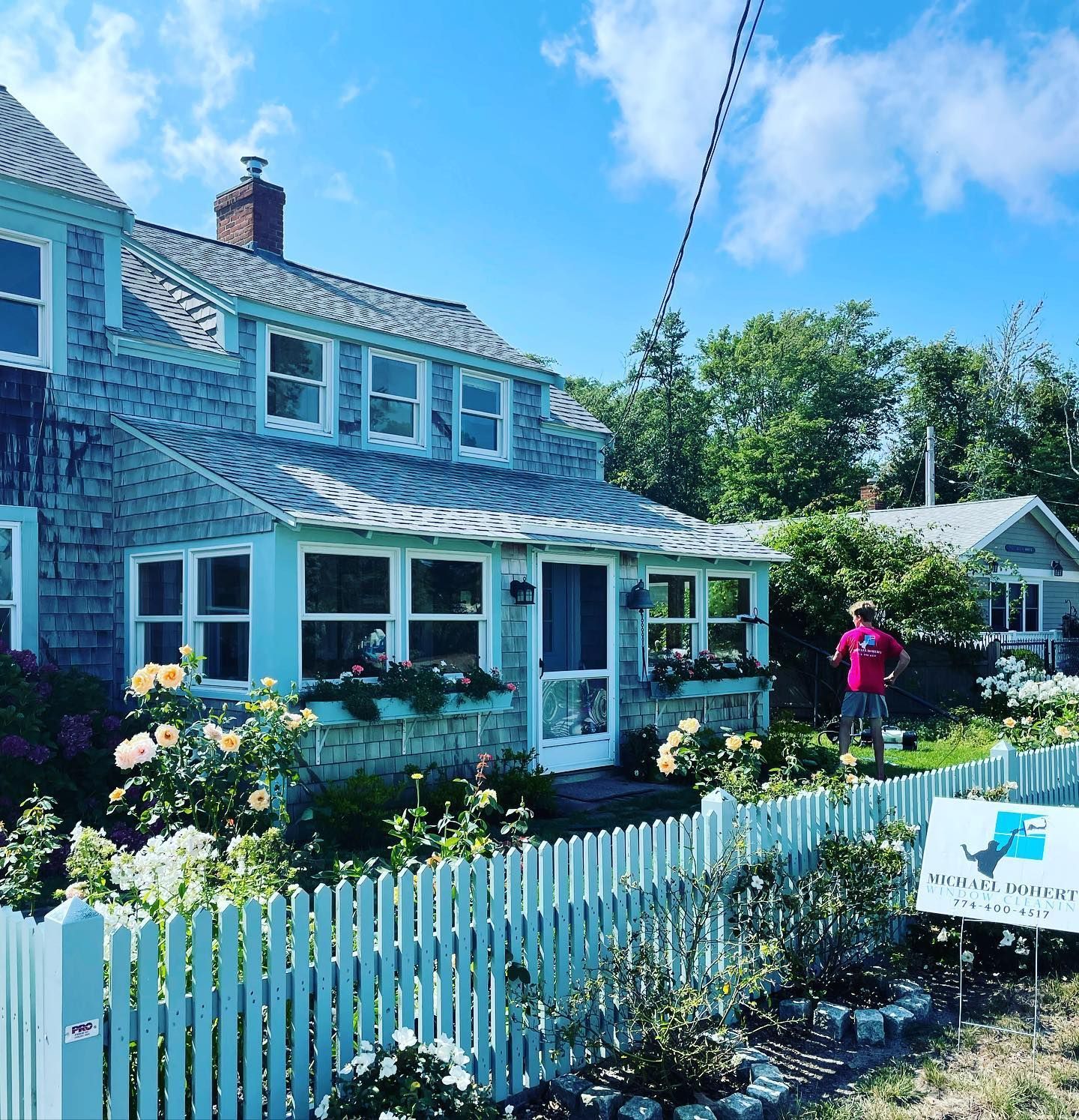 Professional window cleaning service at Cape Cod home with flower garden | Window washing Cape Cod