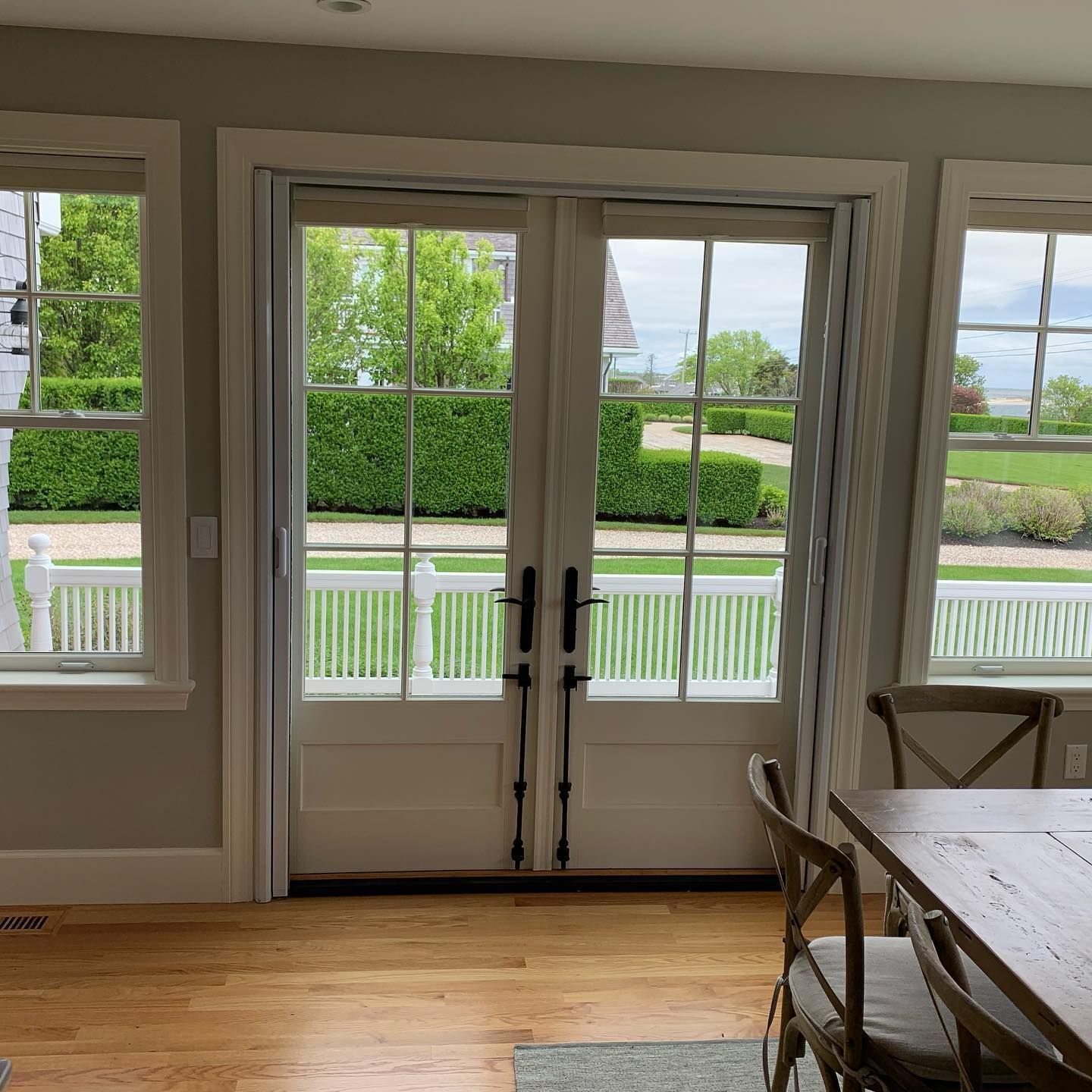 A dining room with a table and chairs and a french door