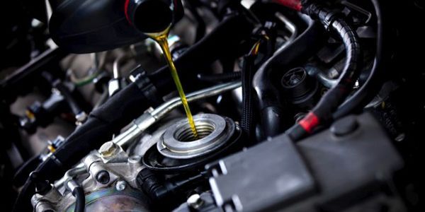 Oil being poured into a car engine.