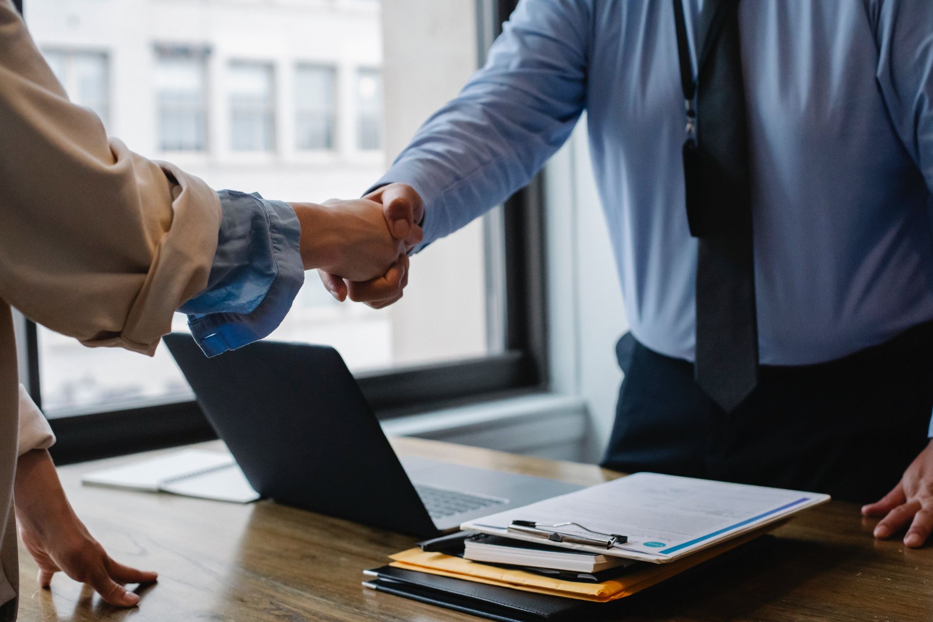 People closing a deal by shaking hands