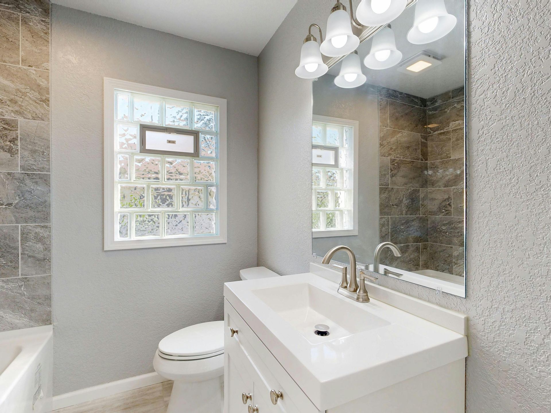 residential bathroom sink and mirror where the sink was recently replaced by gainsville plumbing
