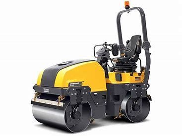 Yellow and black road roller compacting ground.