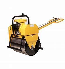 Yellow walk-behind asphalt roller compacting pavement.