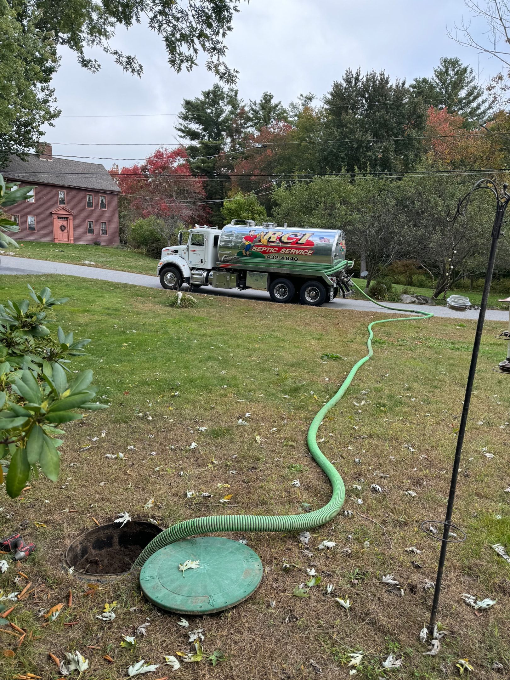 A professional septic service technician performing regular septic tank pumping.