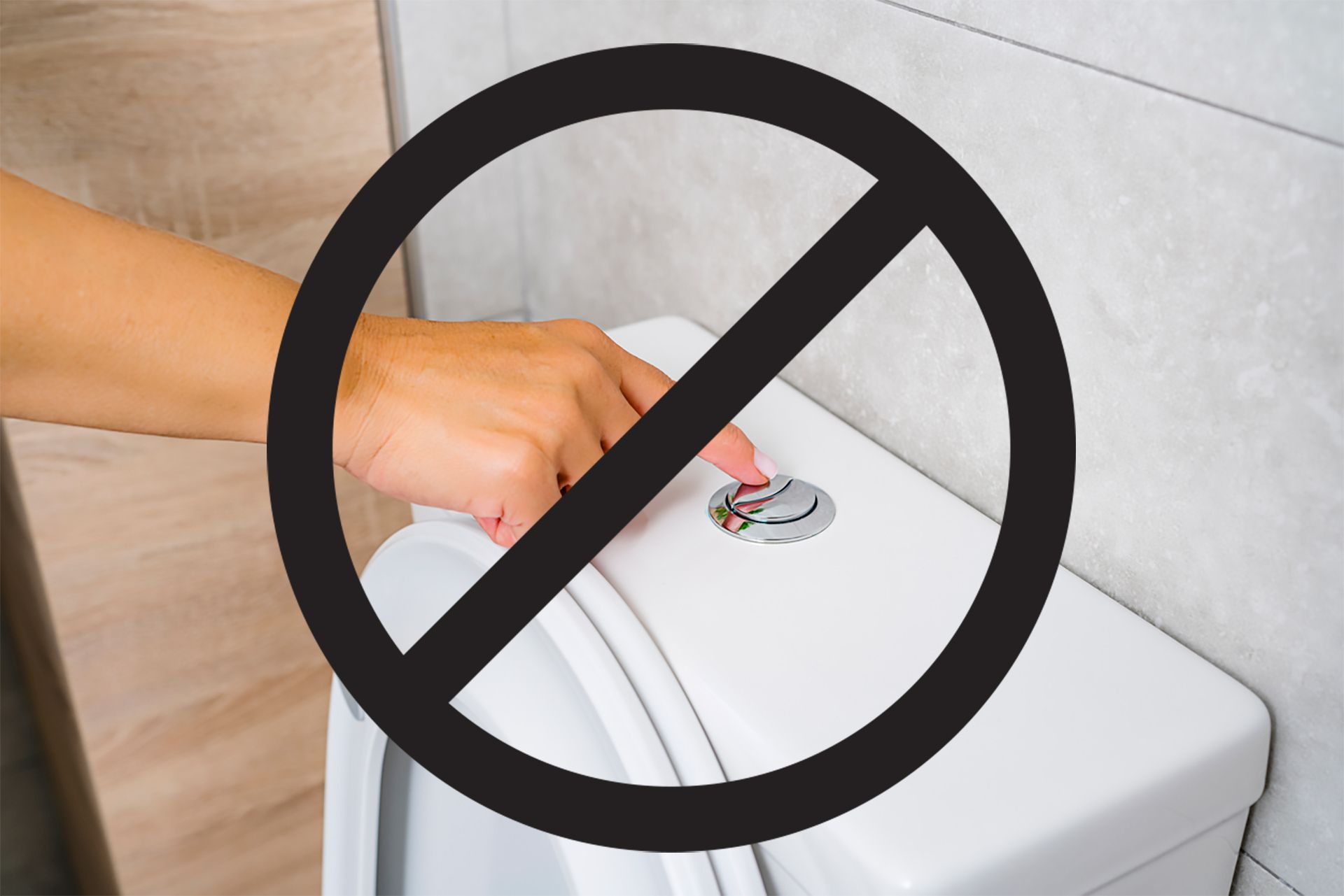 A person is pressing a button on a toilet with a black circle around it.