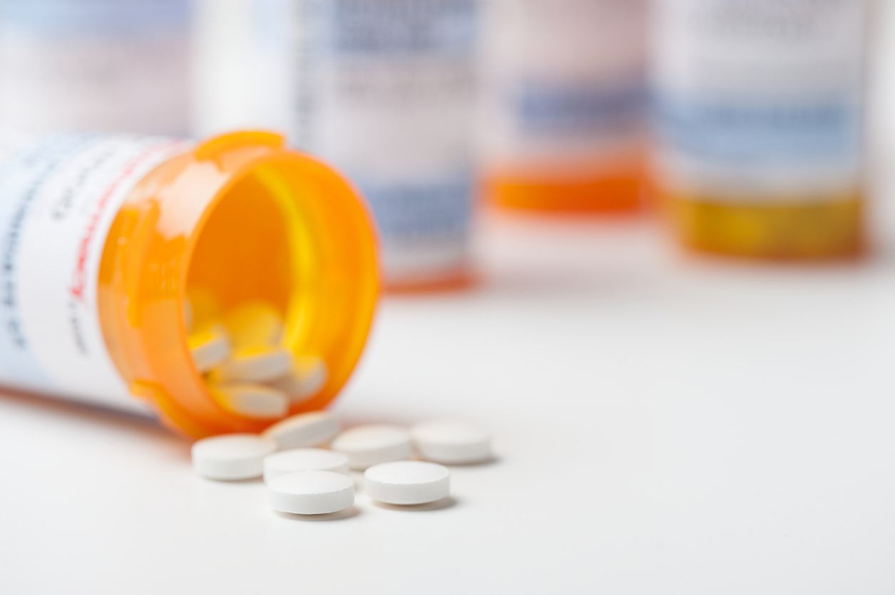 a bottle of pills is spilling out of it on a table .