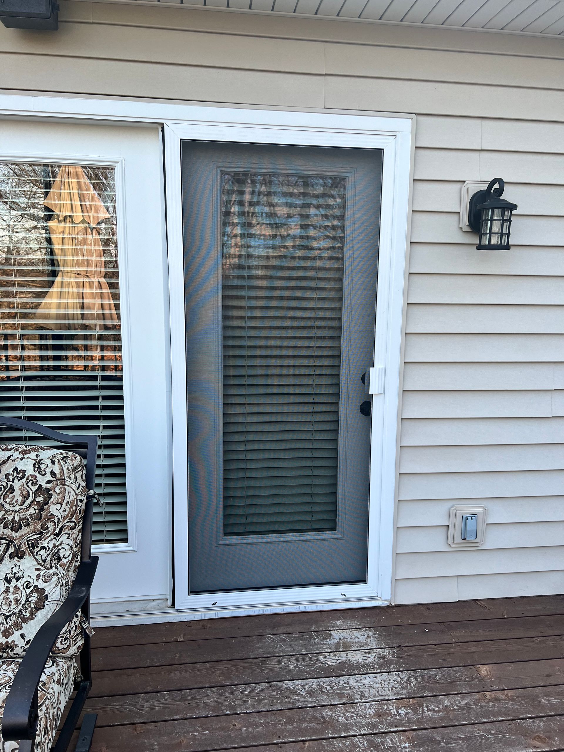 A sliding glass door is on the side of a house.