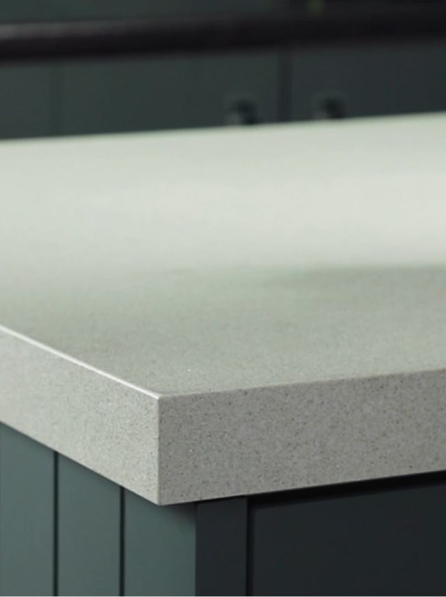 A close up of a white counter top in a kitchen.