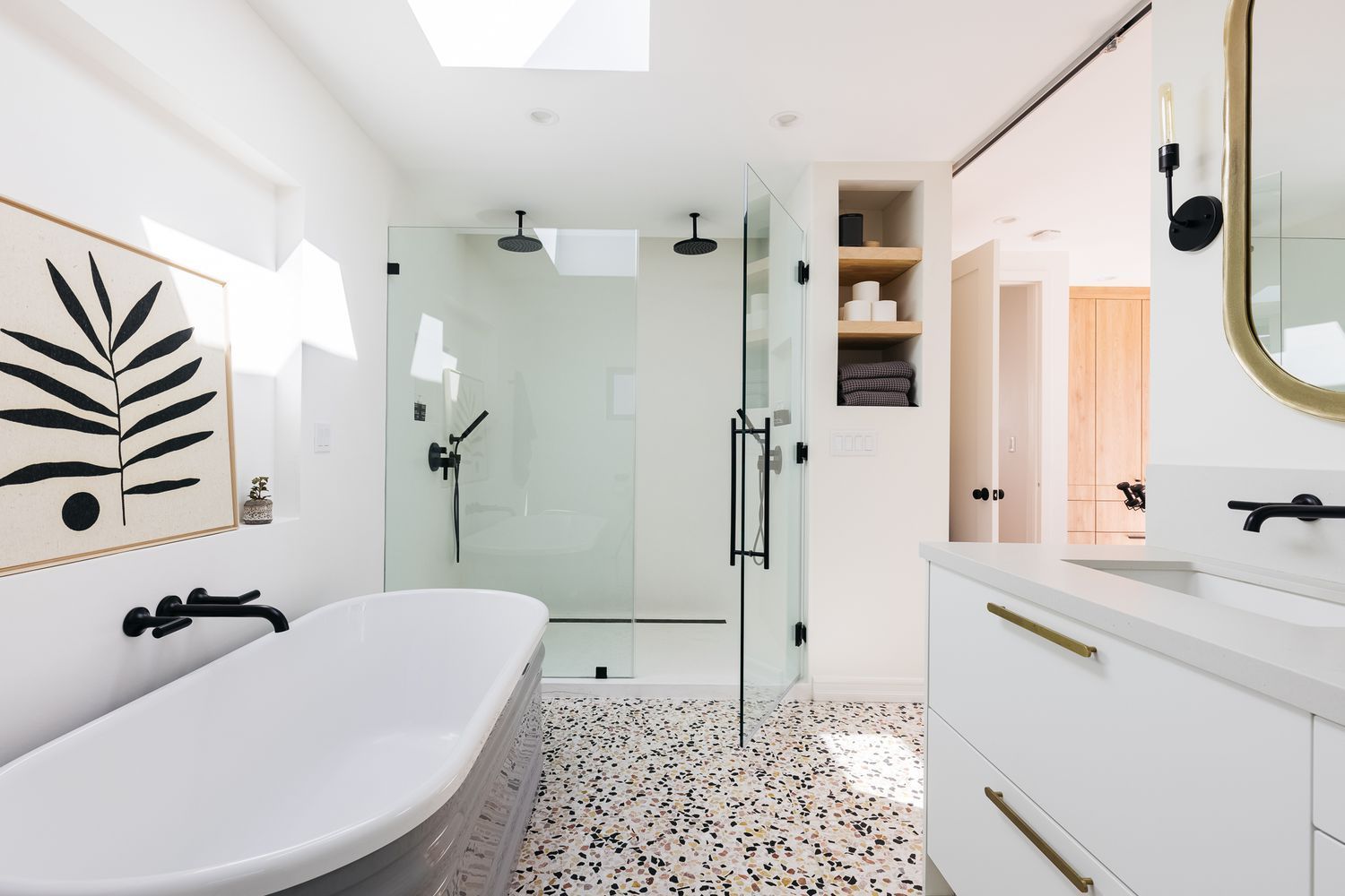 A bathroom with a bathtub, sink, shower and mirror.
