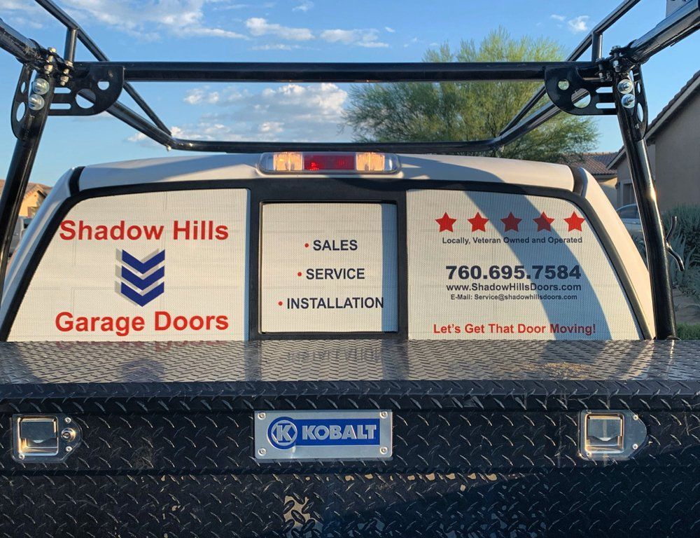 A truck with shadow hills garage doors written on the back window
