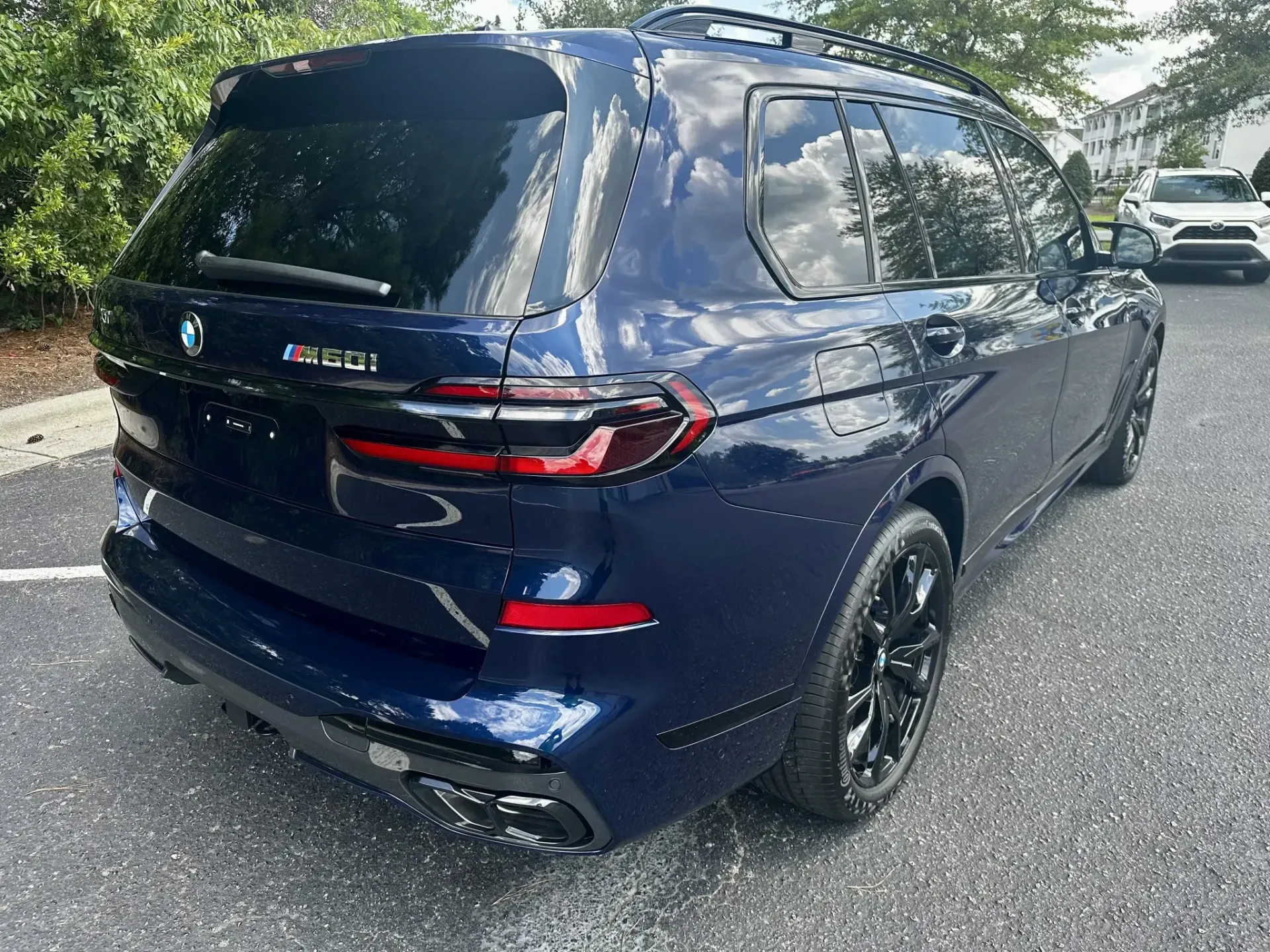 Dark blue Honda minivan parked outdoors in a lot, rear three-quarter view