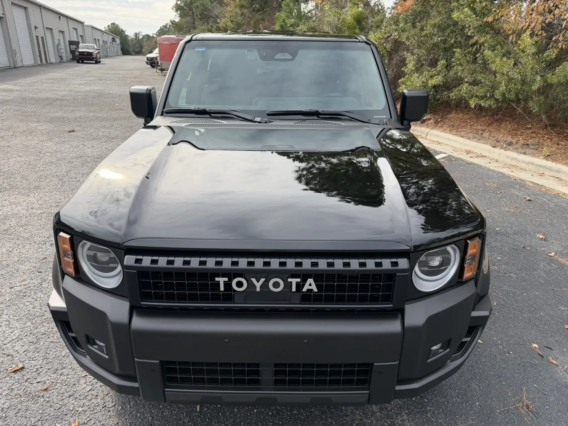 Black Toyota SUV parked on a street, front view