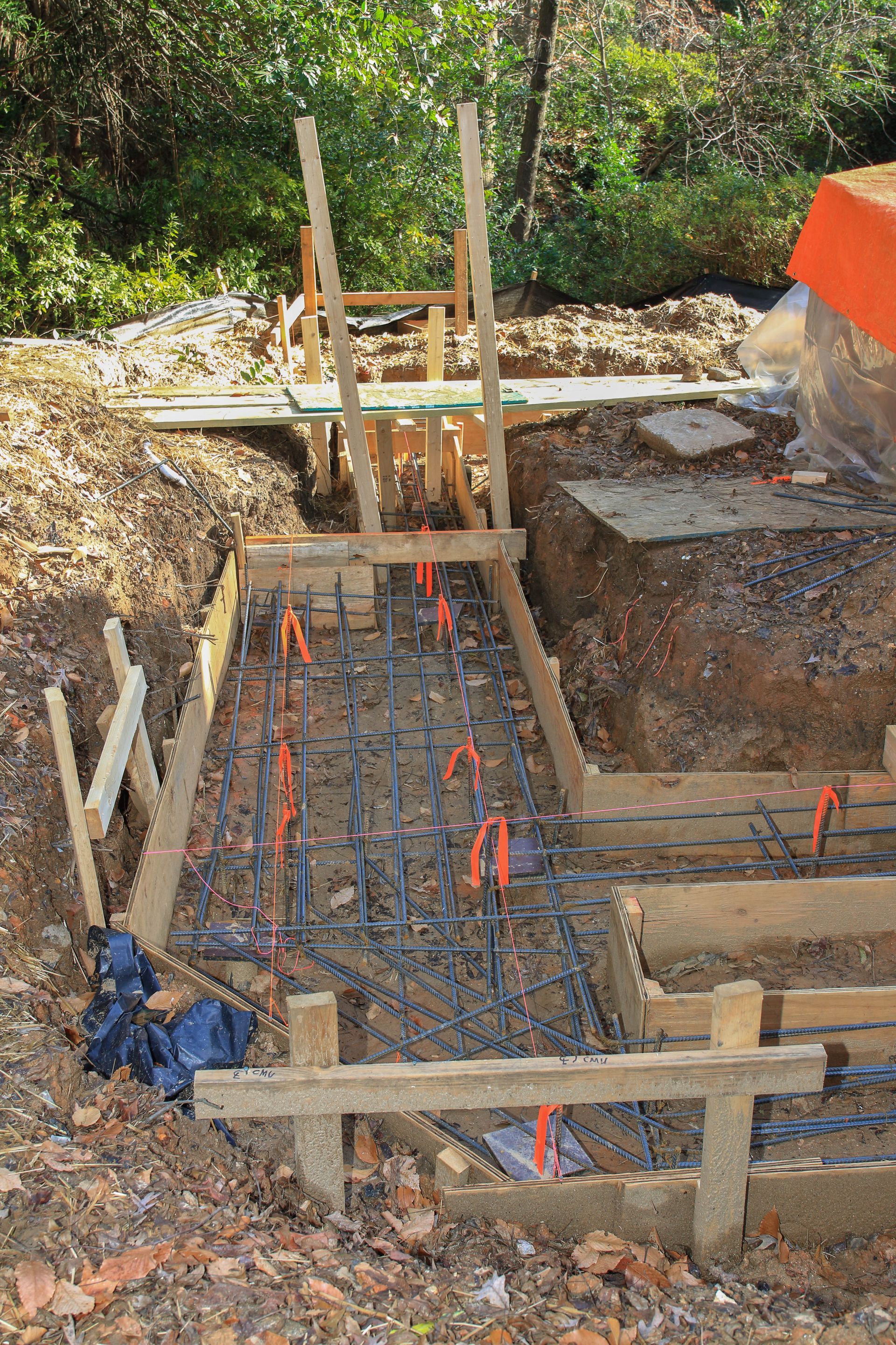Wooden formwork with rebar, ready for concrete pouring, on a construction site.