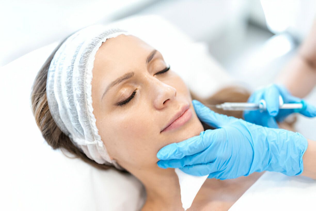 Woman receiving cosmetic facial injection in a medical setting.
