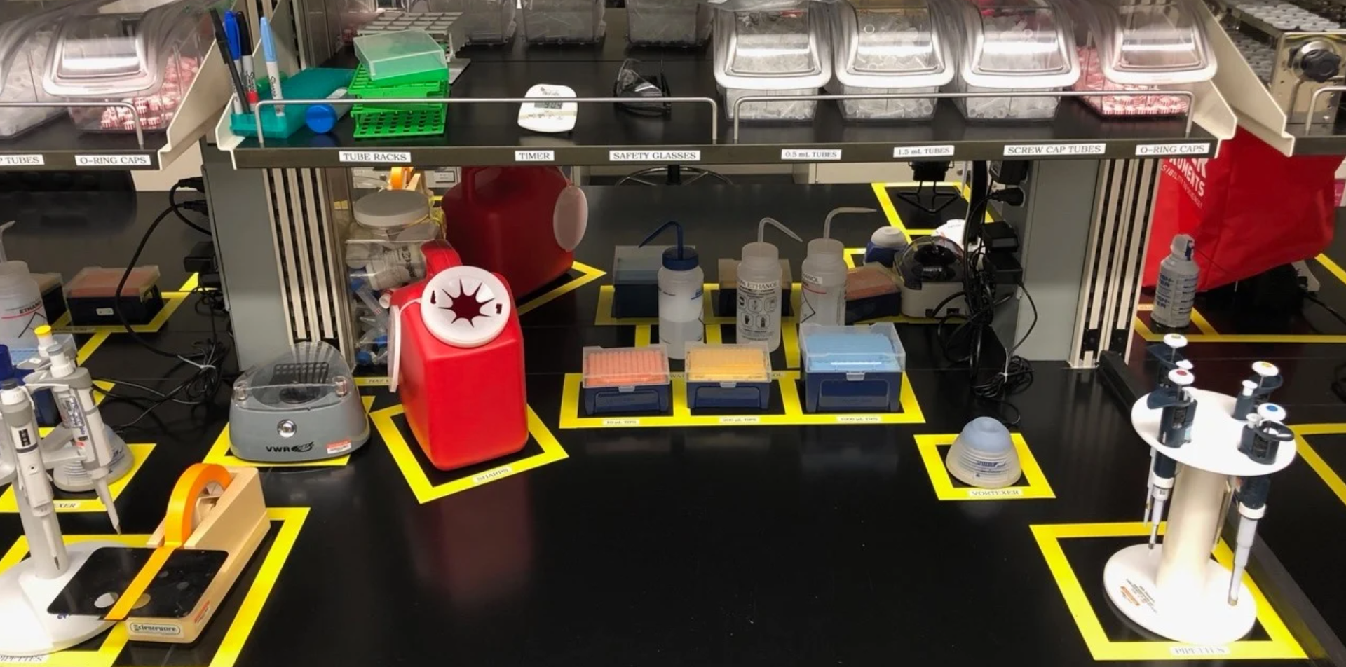 A laboratory workspace with various tools and containers, marked with yellow squares.