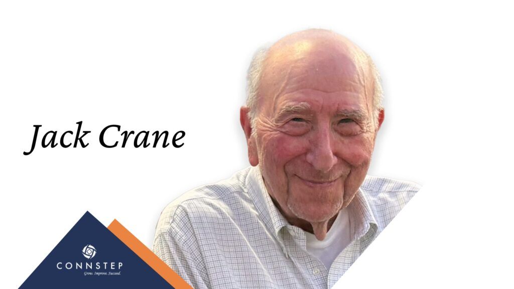 Jack Crane, smiling, in a light-colored shirt, with text