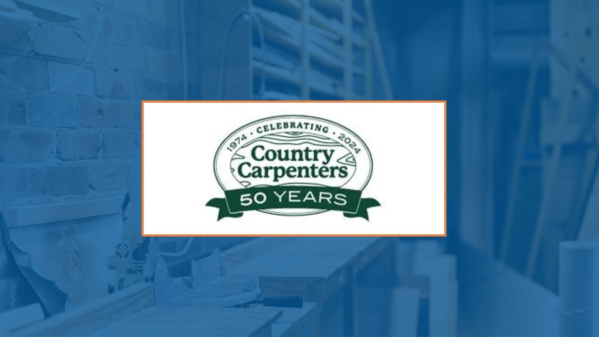 Logo for Country Carpenters, celebrating 50 years, against a blue workshop background.