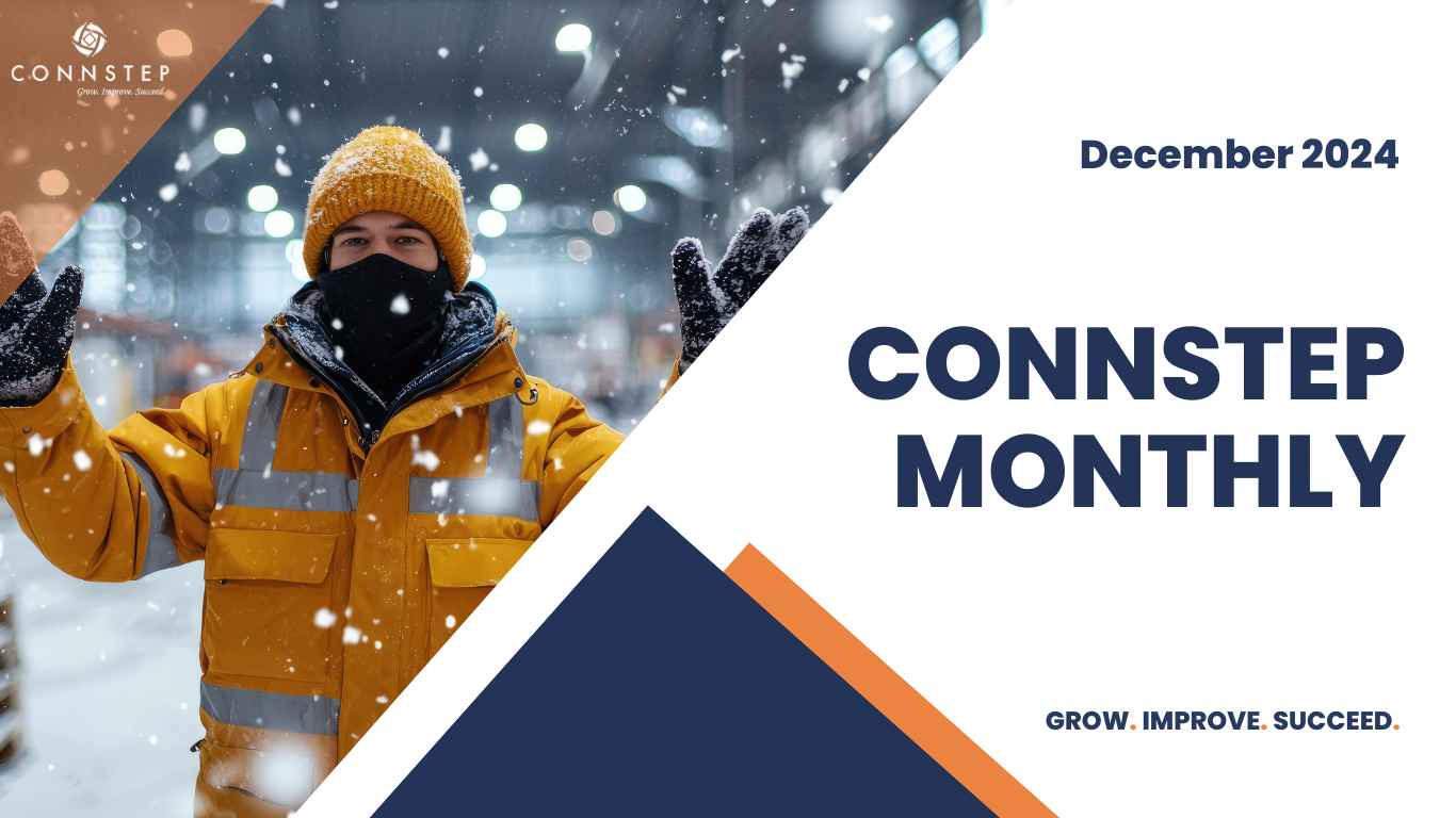 Worker in yellow jacket, hat, and face mask, amidst falling snow;