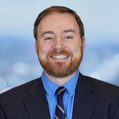 A portrait of Rob Blakely, Chief Financial Officer at CONNSTEP, smiling, looking at the viewer. Blurred background.