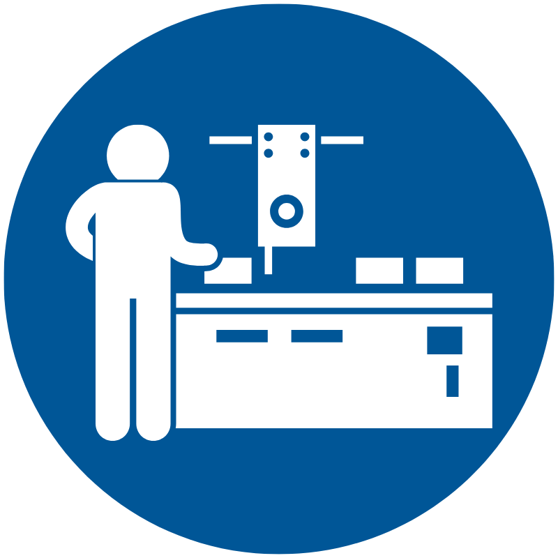 Blue safety sign showing a worker at an industrial machine with tools on a workbench