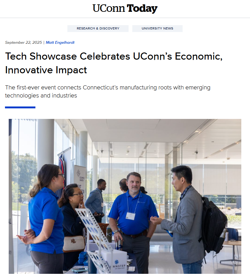 People at a UConn Tech Showcase event, conversing in a modern building.