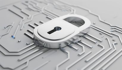Silver padlock on a circuit board, symbolizing cybersecurity.