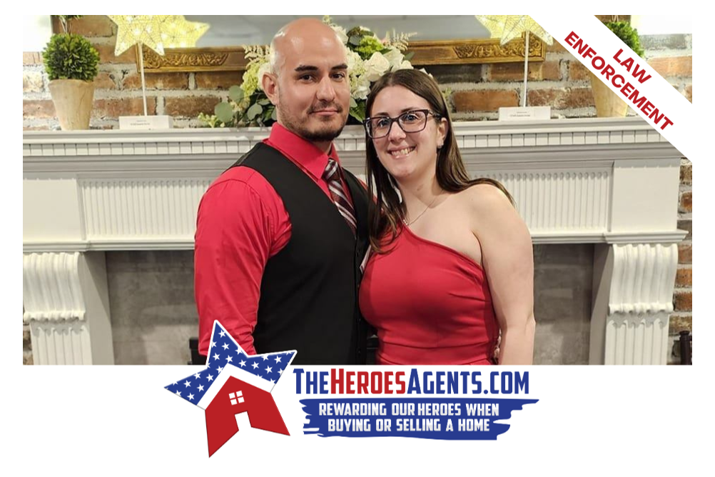 A man and a woman are standing next to each other in front of a fireplace.