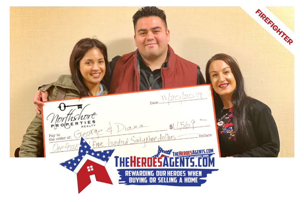 A man and two women are holding a large check.