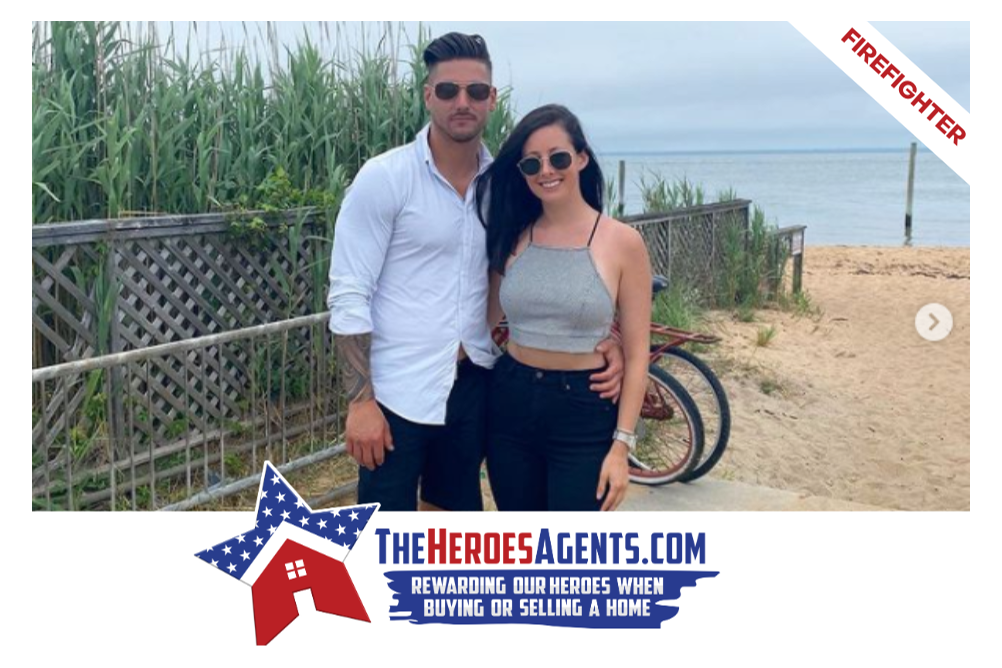 A man and a woman are standing next to each other on a beach.