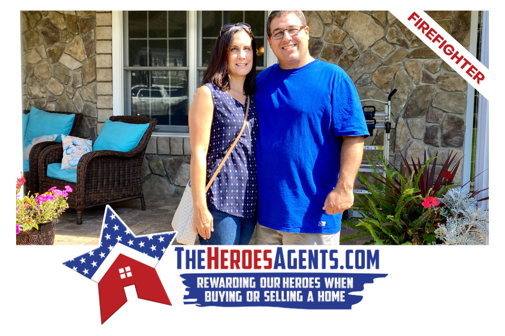 A man and a woman are standing in front of a house.