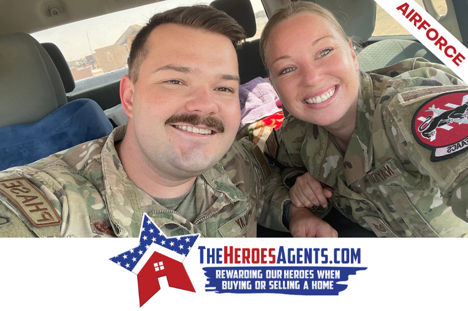 A man and a woman in military uniforms are posing for a picture in a car.