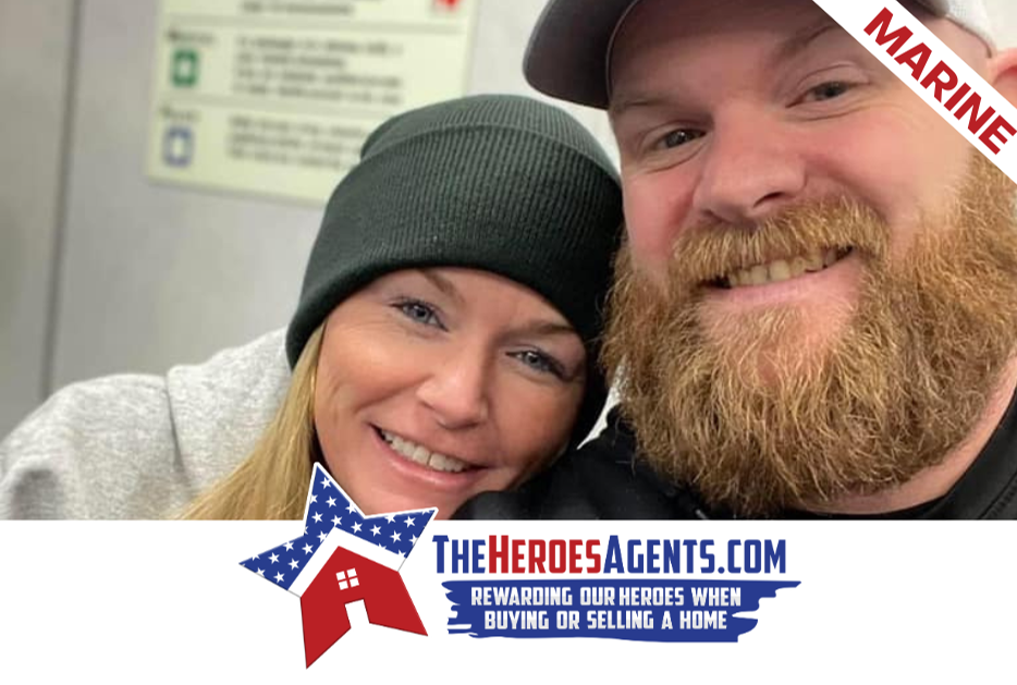 A man and a woman are posing for a picture with the heroesagents.com written on the bottom