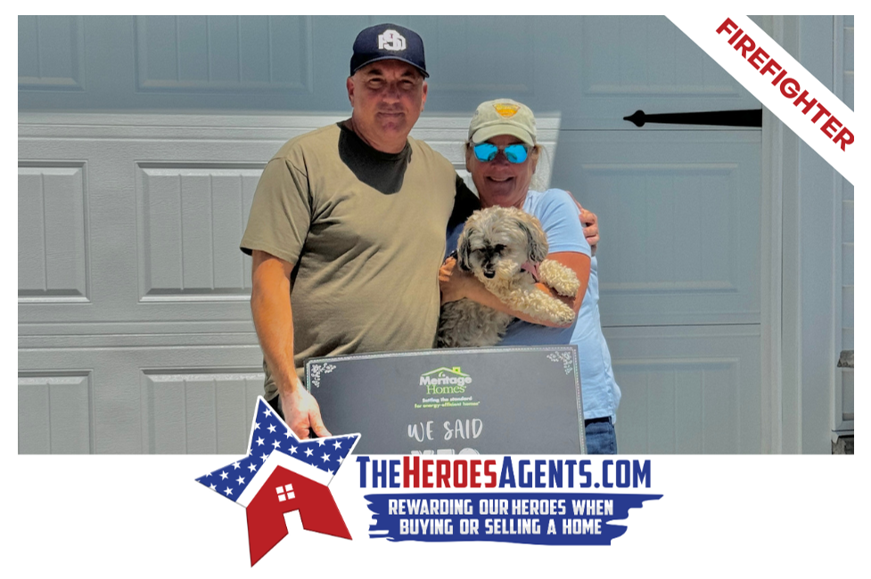 A man and woman are standing next to each other holding a dog.